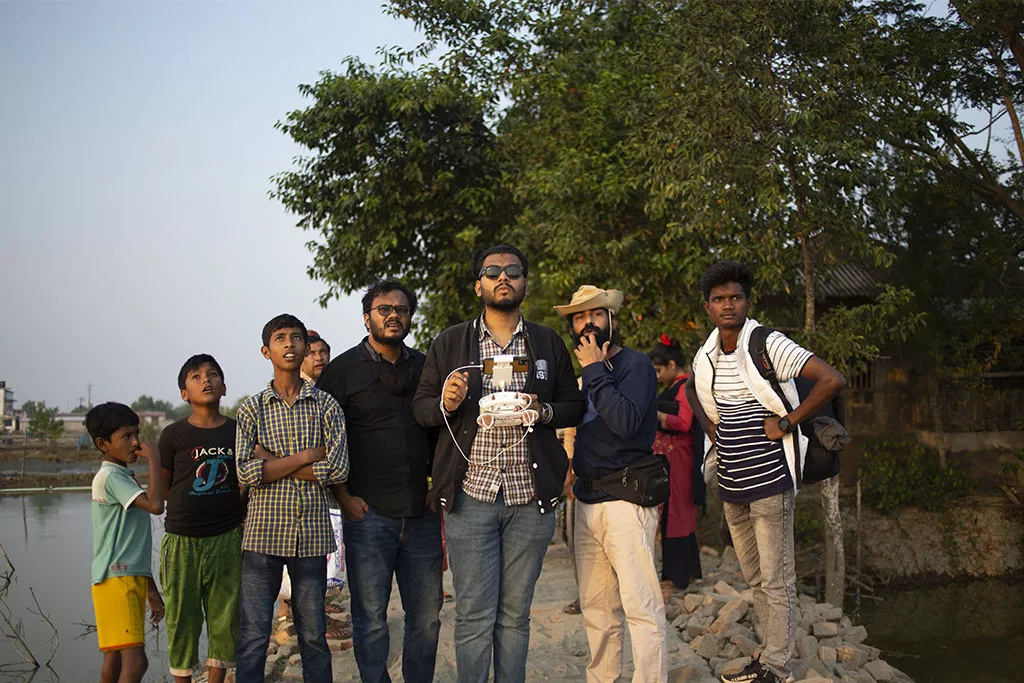 Bangladeshi production fixers preparing equipment for shoot