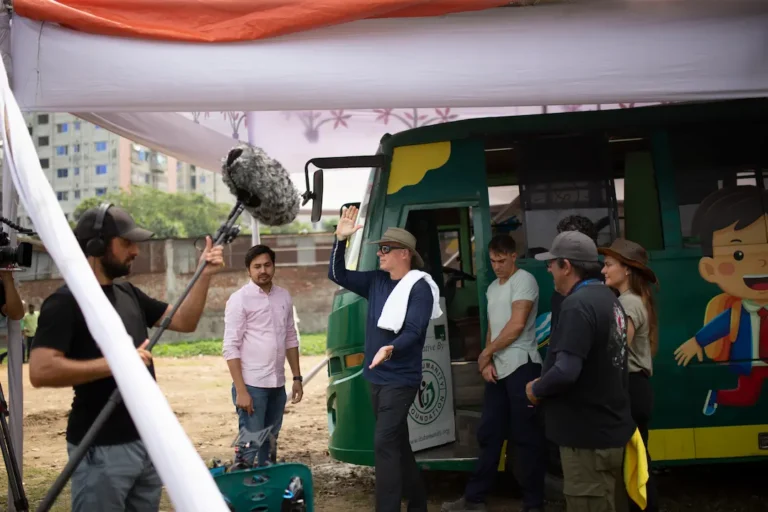 Professional film crew and fixer on location in Bangladesh recording sound