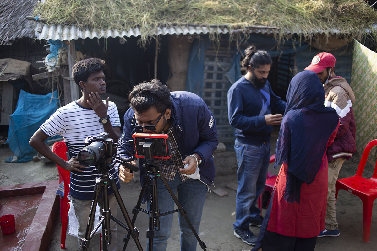 Fixer managing rural village film shoot in Bangladesh with local talent and crew