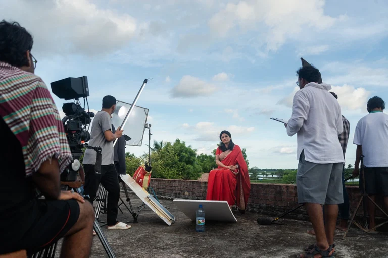 Foreign documentary crew with local fixer and sound recordist filming on location in Bangladesh