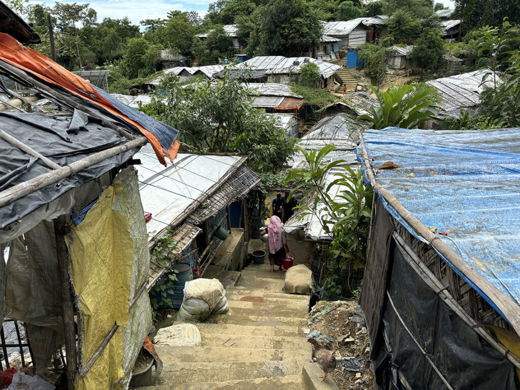 Narrow pathways and terrain conditions inside Rohingya camp affecting filming logistics and crew movement in Cox's Bazar Bangladesh
