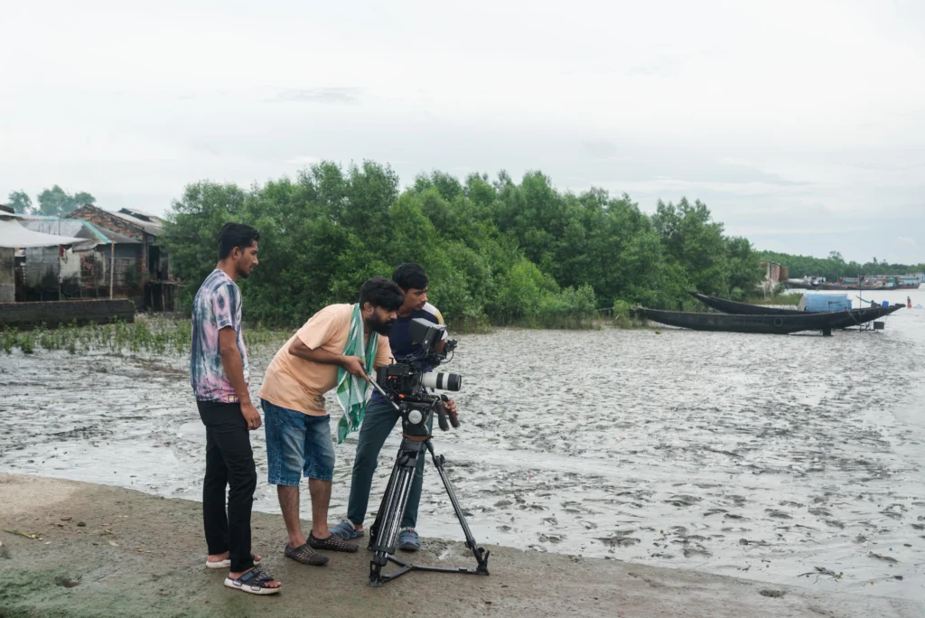 Local Bangladeshi documentary crew filming an interview with a community member in the Sundarbans region